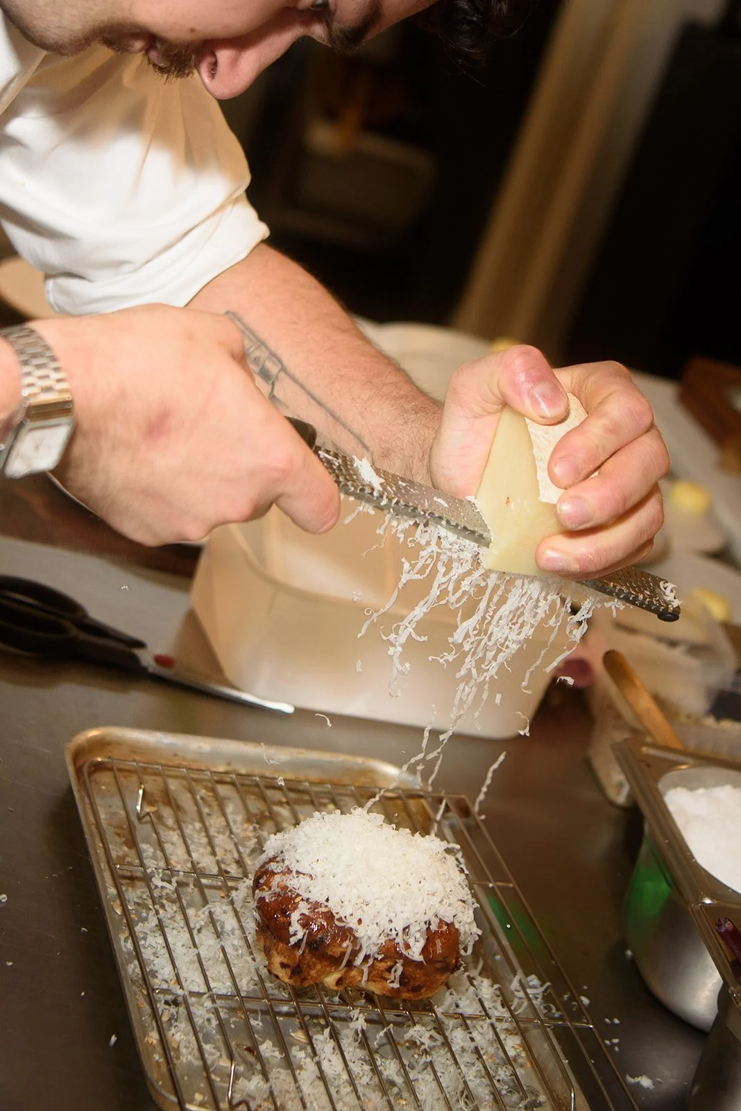 Cheese shaved by hand from a whole wheel in the kitchen