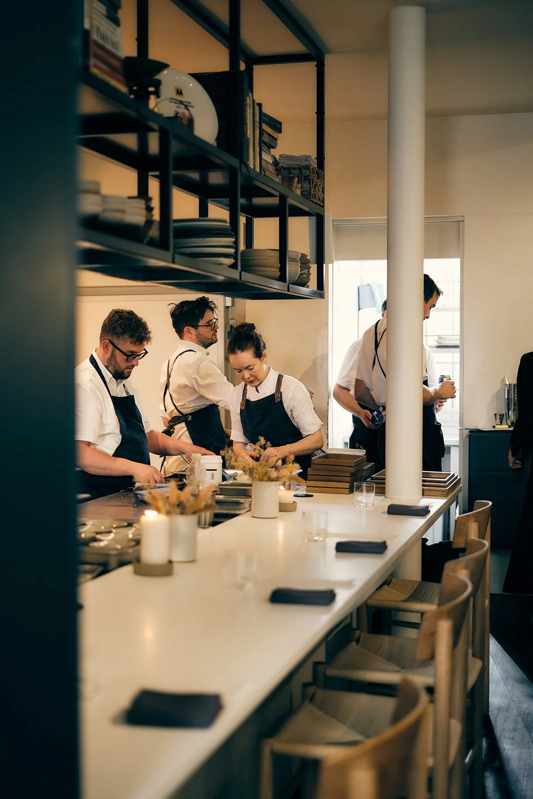 The kitchen team plating during service in the open kitchen