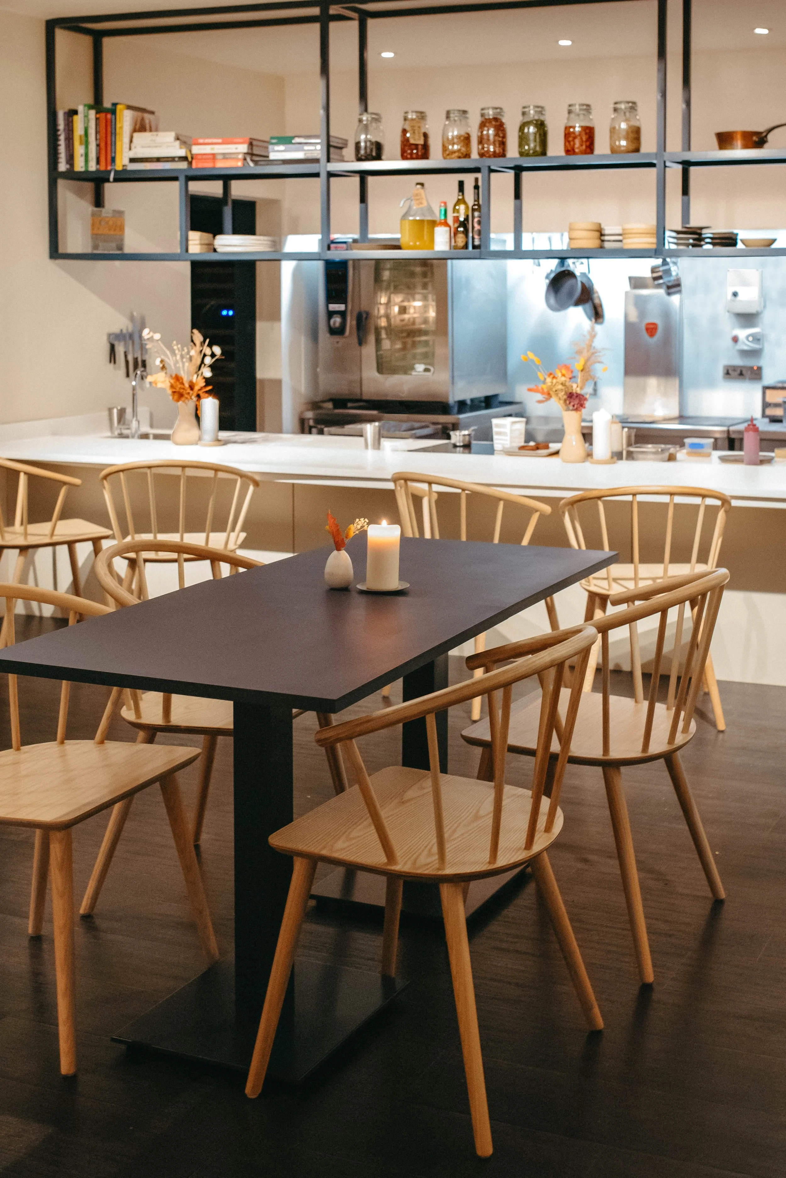 The Little Chartroom dining room — spindle-back chairs, candlelight and dried flowers